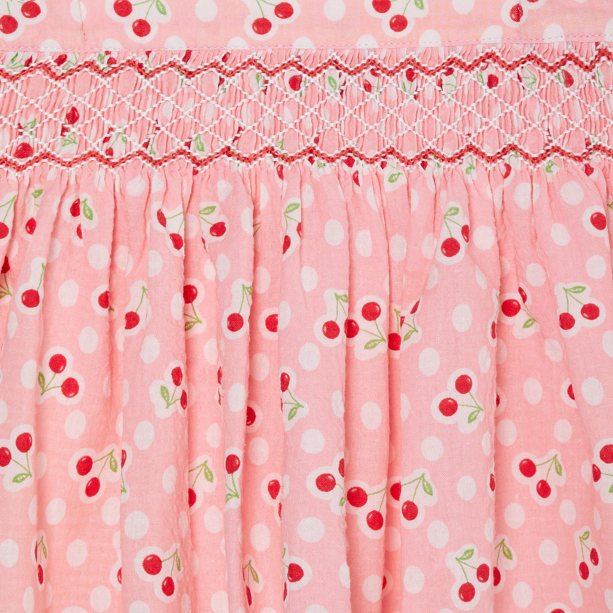 pink cherry print skirt with hand smocking, front, smocked detail 