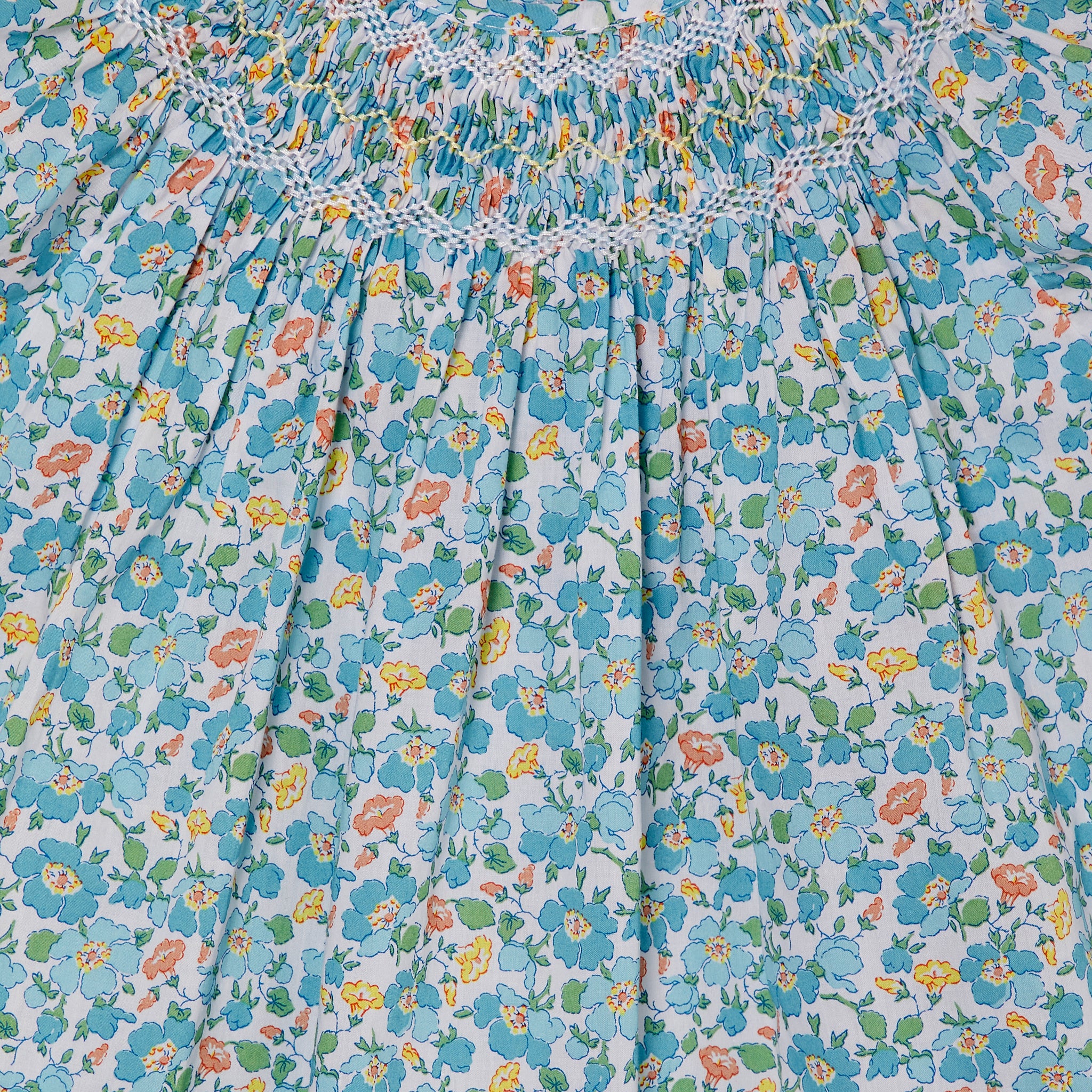 blue floral hand-smocked girls blouse, closeup