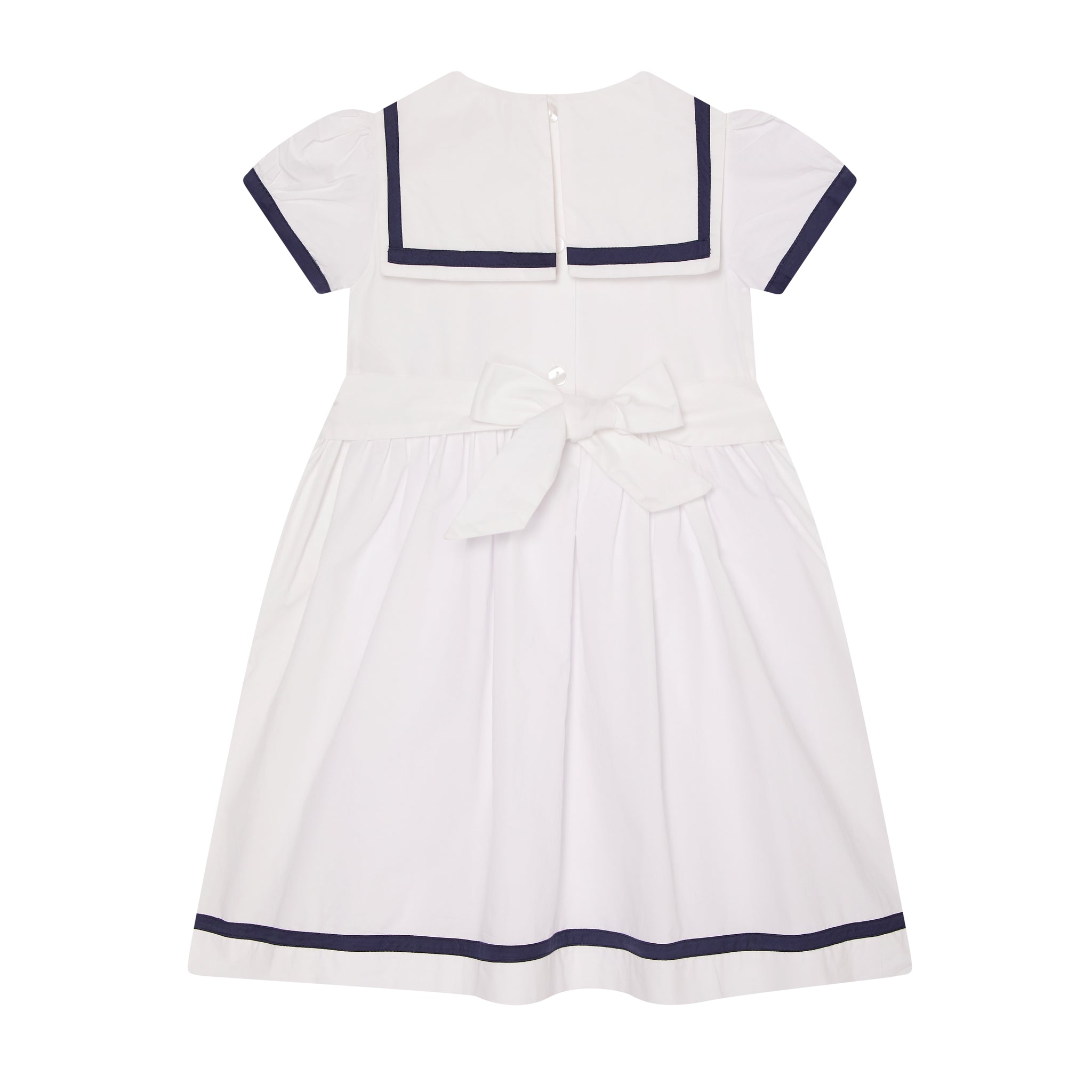 crisp white sailor dress with nary trims and star embroidery, back